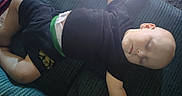 Zaidyn joined the competition — help win amazing prizes! arm, baby, black_shirt, casual_clothing, child, comfort, couch, face, furniture, head, home, indoor, peaceful, relaxed, resting, shorts, skin, sleeping, soft_light, toddler