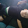 baby, sleeping, couch, child, relaxed, indoor, peaceful, casual_clothing, black_shirt, shorts, toddler, resting, soft_light, furniture, home, comfort, skin, head, face, arm