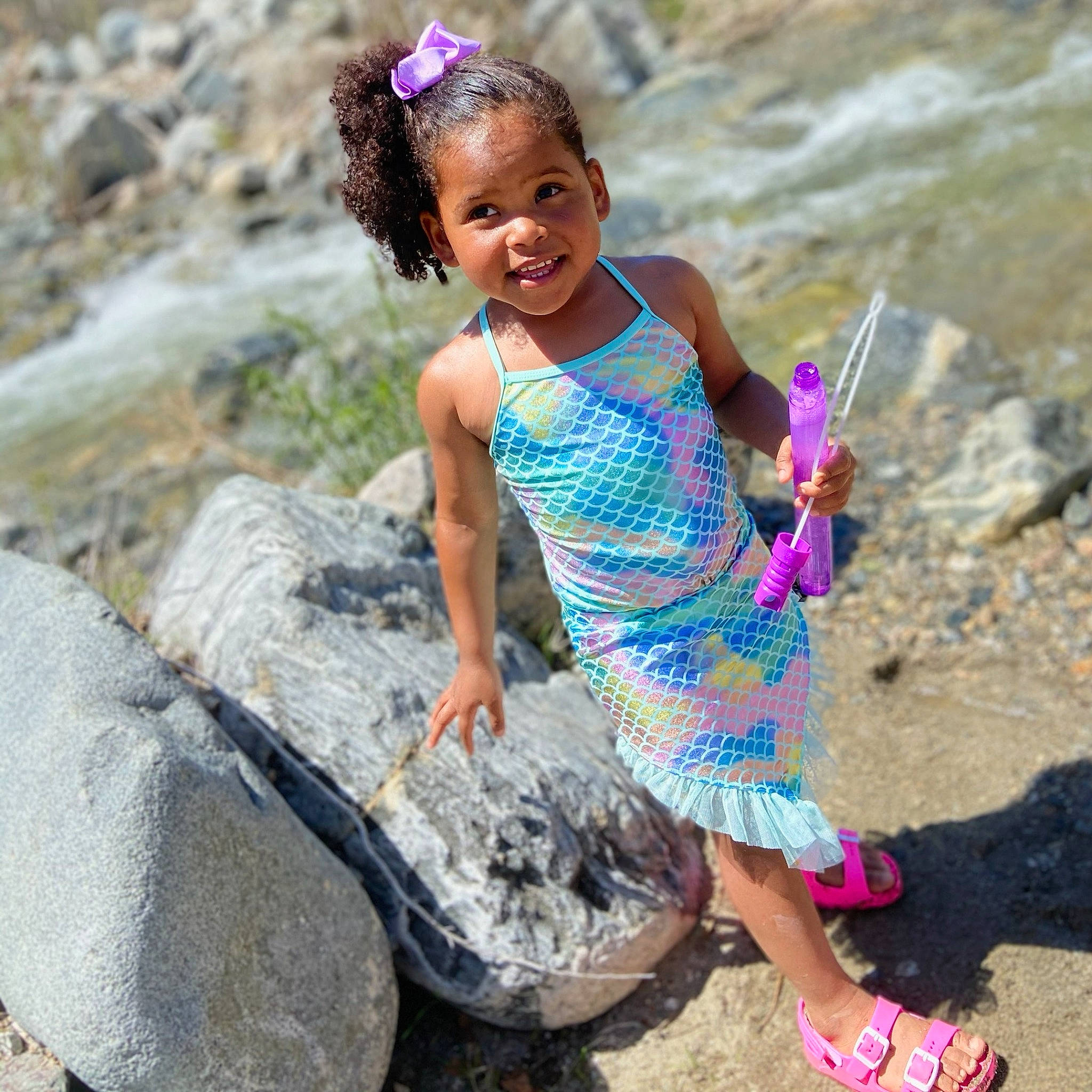 Layla is registered to the contest to win money with this photo: adaptation, child, dress, flip_flops, foot, fun, grass, hair, happy, human_leg, joy, landscape, leg, leisure, people_in_nature, person, pink, recreation, sandal, smile