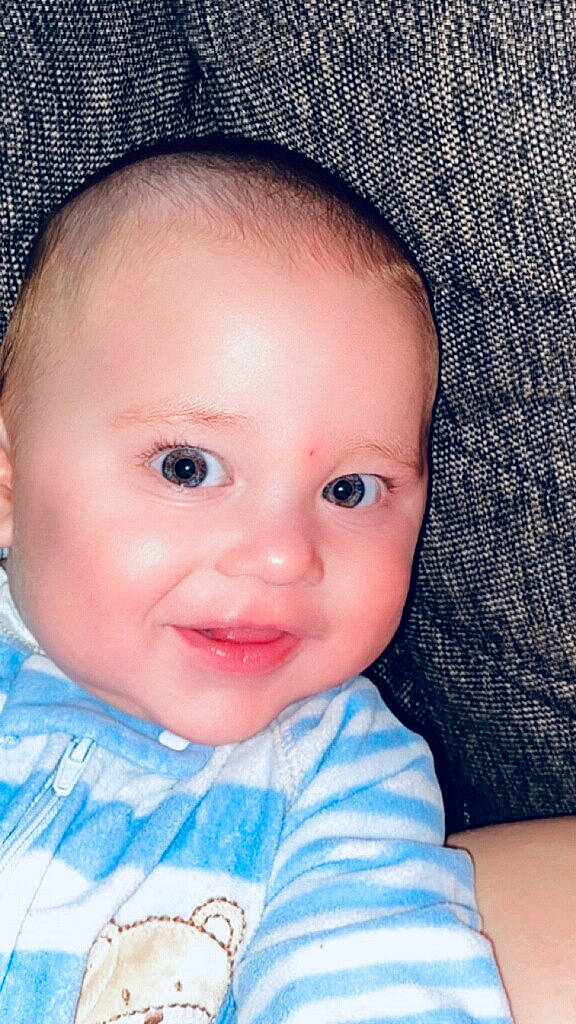 Enrique Oswald is registered to the contest to win money with this photo: azure, baby, baby_toddler_clothing, cheek, chin, ear, eye, eyebrow, eyelash, finger, hair, iris, lip, mouth, neck, nose, person, skin, sleeve, smile
