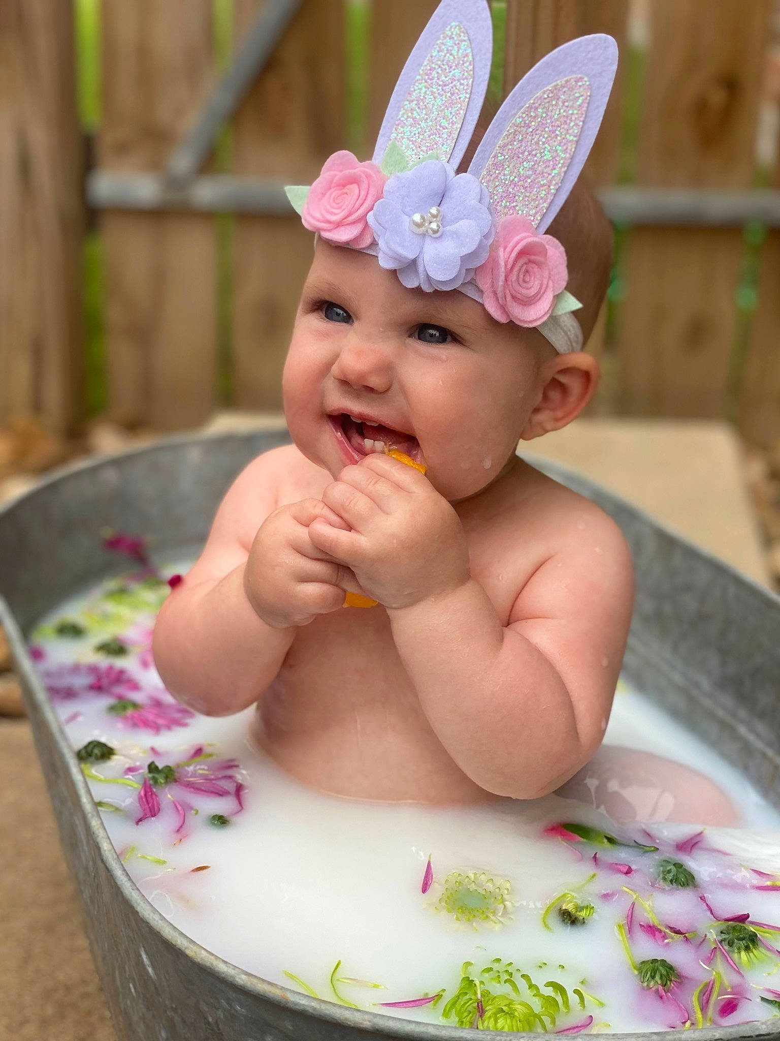 Hattie is registered to the contest to win money with this photo: baby, baby_toddler_clothing, cap, child, costume_hat, face, food, fun, happy, head, headband, headpiece, headwear, lip, party_supply, person, pink, plant, skin, smile