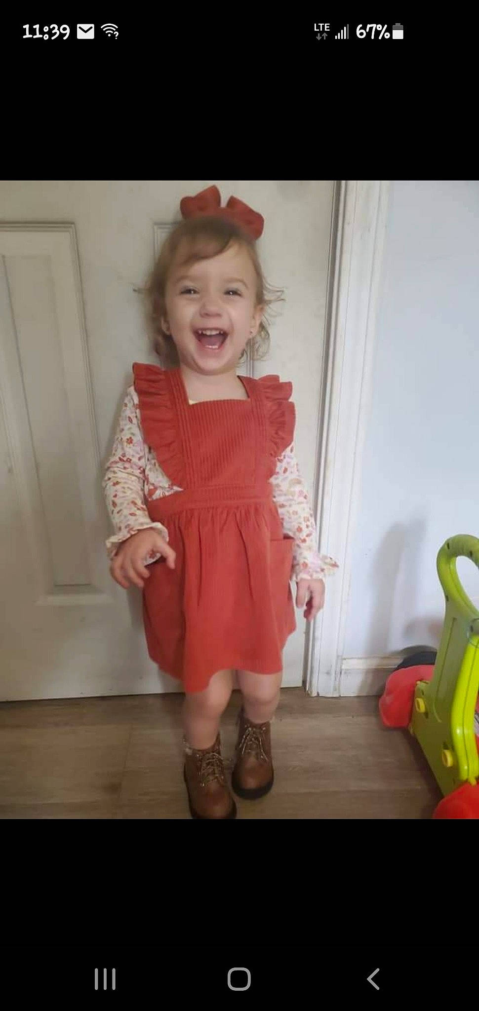 Calliope joined the competition — help win amazing prizes! baby_toddler_clothing, child, day_dress, door, dress, floor, flooring, happy, human_body, human_leg, joy, knee, one_piece_garment, person, skin, sleeve, smile, sock, standing, thigh