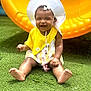 baby, child, smiling, sunhat, yellow_bib, green_grass, yellow_slide, outdoor, summer, playground, cute, happy, sitting, infant, toddler, pacifier, toy, sunny, play, portrait