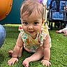 baby, child, crawling, grass, playground, outdoor, colorful_clothing, stroller, toy, infant, smiling, person, cute, young_child, sunlight, happy, greenery, feet, hands, playtime