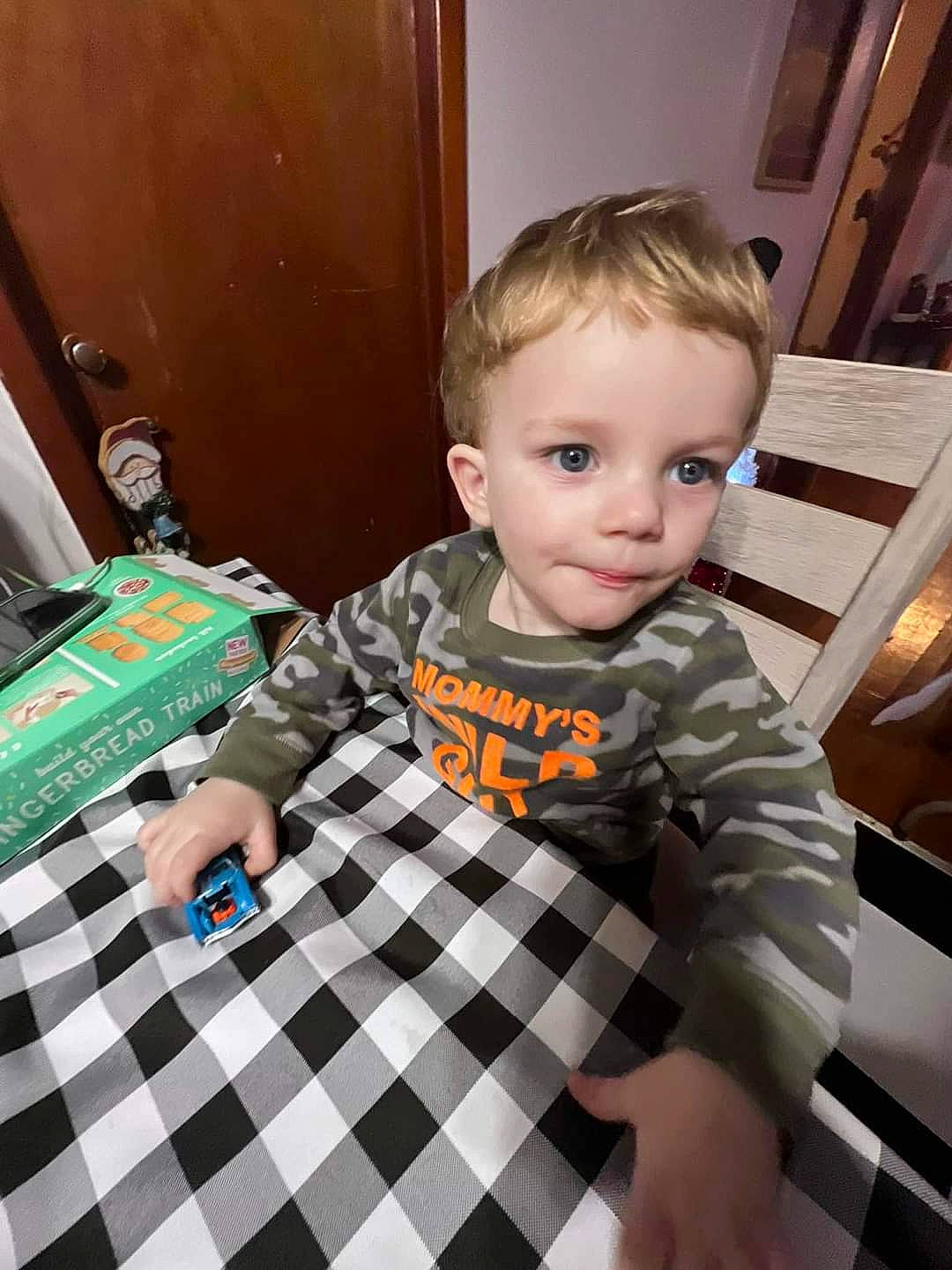 Tanner is registered to the contest to win money with this photo: baby_toddler_clothing, child, drawer, floor, flooring, fun, hardwood, indoor_games_and_sports, pattern, person, plaid, play, room, sitting, sleeve, t_shirt, toddler, varnish, wood