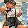 baby, child, boy, hat, bow_tie, suspenders, shorts, white_shirt, toy, knitted_blanket, blue, white, sitting, barefoot, cute, indoor, portrait, smiling, happy, face