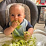 Simon is registered to the contest to win money with this photo: baby, high_chair, bib, food, messy, avocado, kitchen, face, hands, feeding, child, infant, table, expression, cute, home, smearing, eating, person, young_child