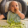 baby, high_chair, bib, green_food, messy, feeding_time, child, infant, cute, food, smiling, kitchen, table, face, hand, eating, fun, indoor, person, plush