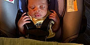 Rayne is registered to the contest to win money with this photo: baby, infant, sleeping, car_seat, headband, bow, blanket, safety_strap, peaceful, indoors, child, cute, serene, portrait, young_child, face, hands, clothing, soft_light, resting
