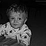 Timéo a rejoint le concours — aidez-le/la à gagner de superbes lots ! toddler, child, face, smile, curly_hair, table, food, hand, long_sleeve_shirt, patterned_clothing, indoors, black_and_white, portrait, cute, young_child, expression, eyes, sitting, wood, casual