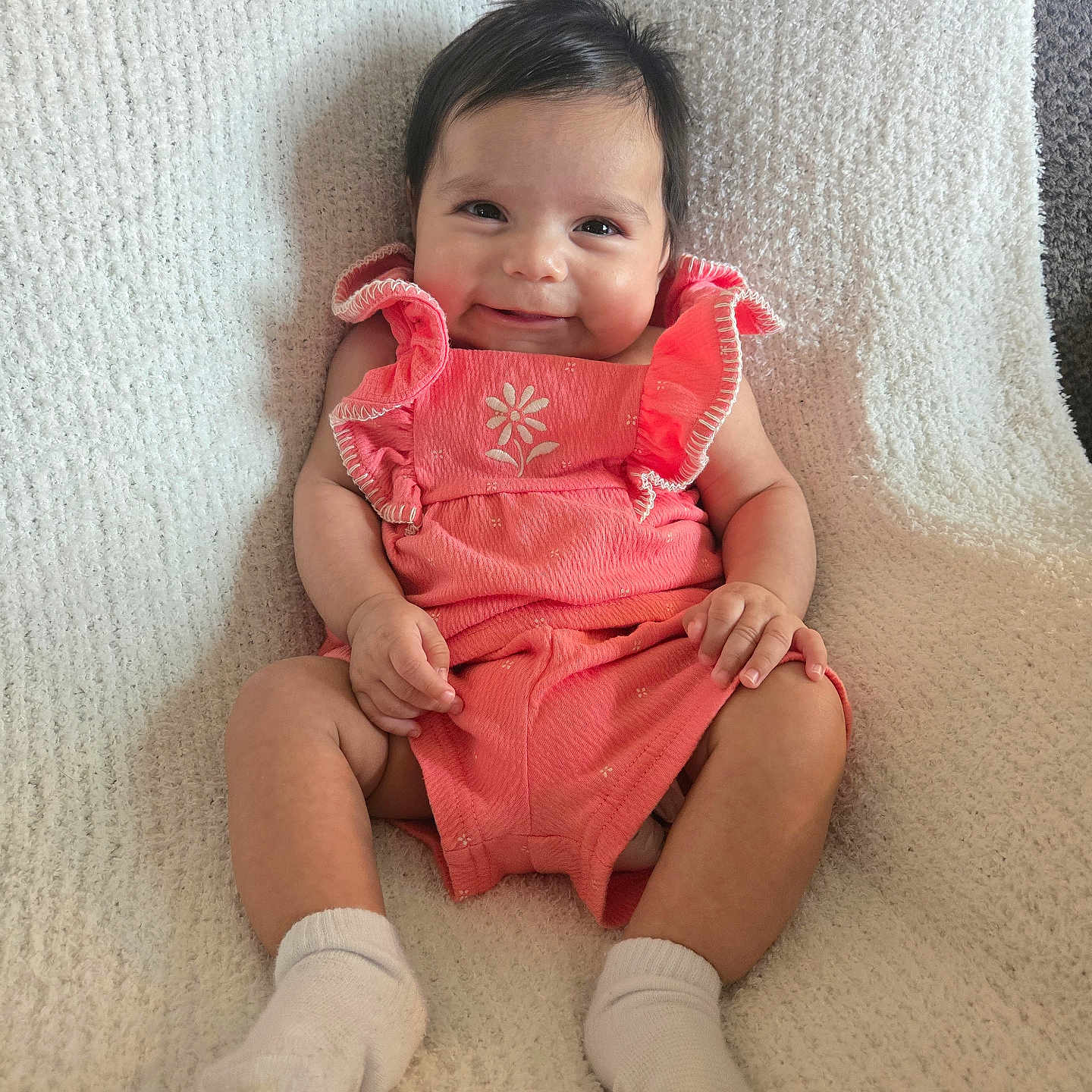 Kenia Yulissa joined the competition — help win amazing prizes! baby, infant, smile, happy, cute, child, sitting, clothing, socks, blanket, texture, portrait, indoors, young_child, face, person, pink_outfit, soft_lighting, comfortable, cozy