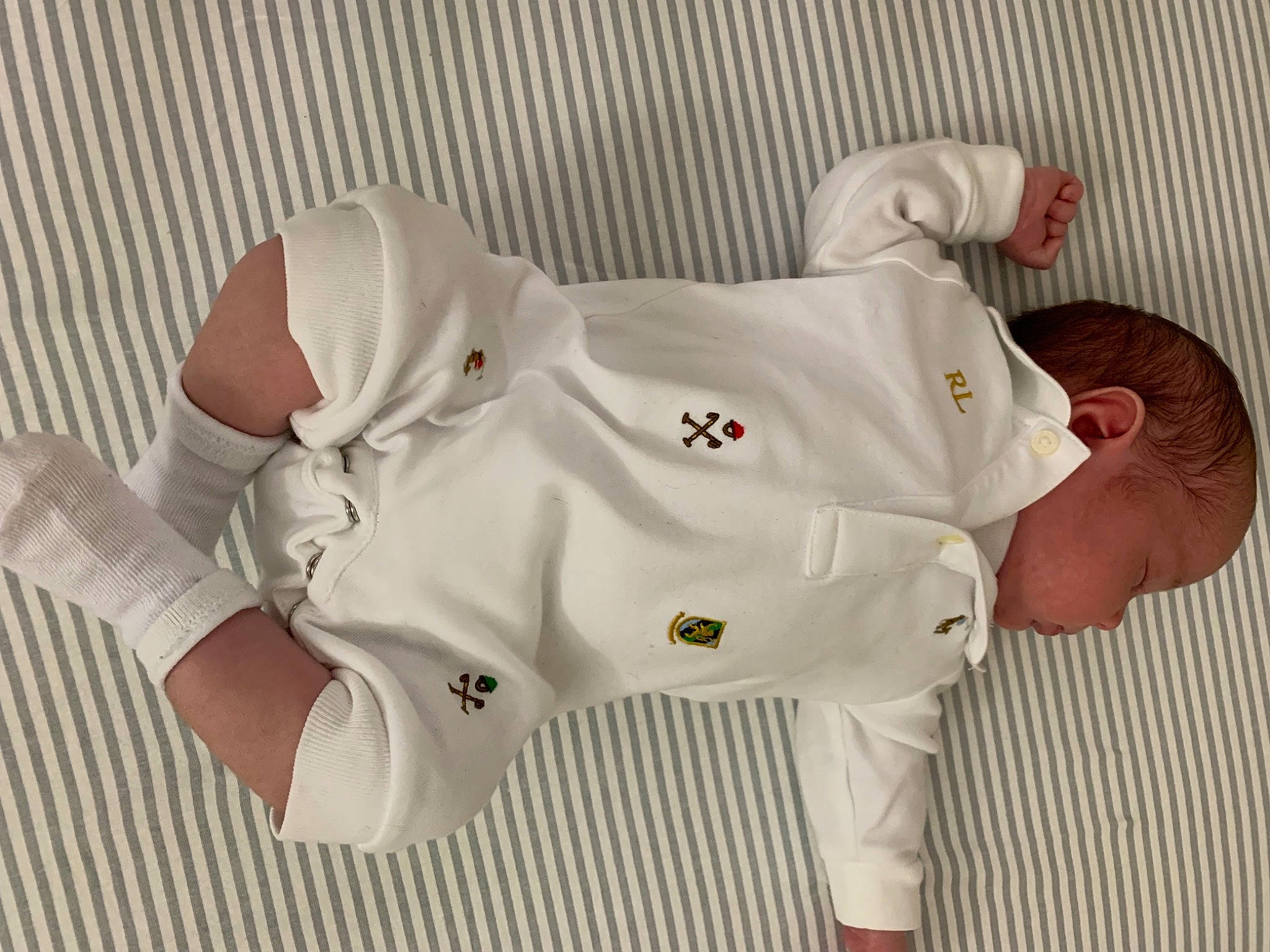 Chase is registered to the contest to win money with this photo: baby_toddler_clothing, carmine, child, comfort, font, foot, human_leg, knee, linens, pattern, person, personal_protective_equipment, product, room, sleeve, sock, sportswear, textile, thigh, thumb