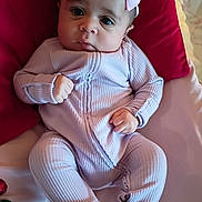 Baeleigh joined the competition — help win amazing prizes! baby, infant, newborn, headband, bow, onesie, pink_clothing, pillow, blanket, chubby_cheeks, big_eyes, hands, lying_down, portrait, cute, nursery, indoor, soft_lighting, fabric, ornament