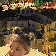 Jana participe au concours pour gagner de l'argent avec cette photo : child, toddler, night, cityscape, buildings, sign, cannes, hair_buns, curious, finger_in_mouth, outdoor, lights, trees, portrait, young_child, person, urban, evening, cute, innocence