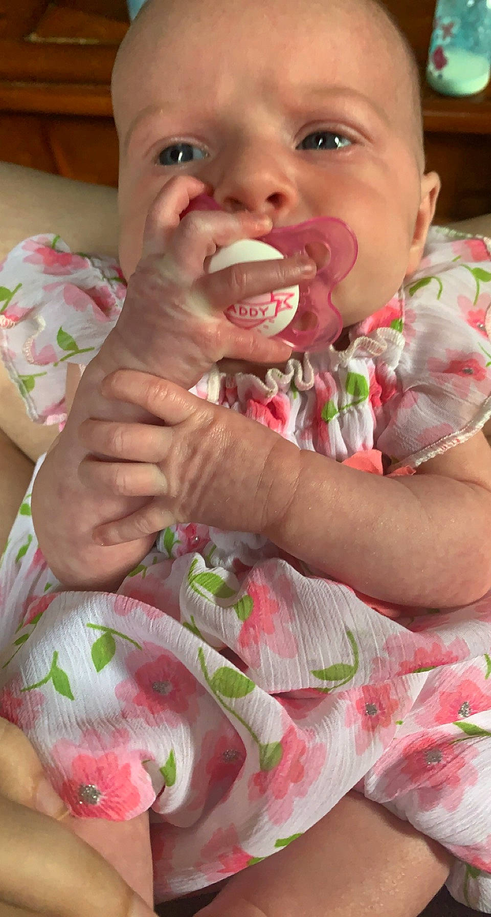 Mary is registered to the contest to win money with this photo: arm, baby, baby_toddler_clothing, cheek, finger, gesture, green, hand, happy, lip, mouth, nose, person, pink, product, skin, textile, toddler, tongue, tooth