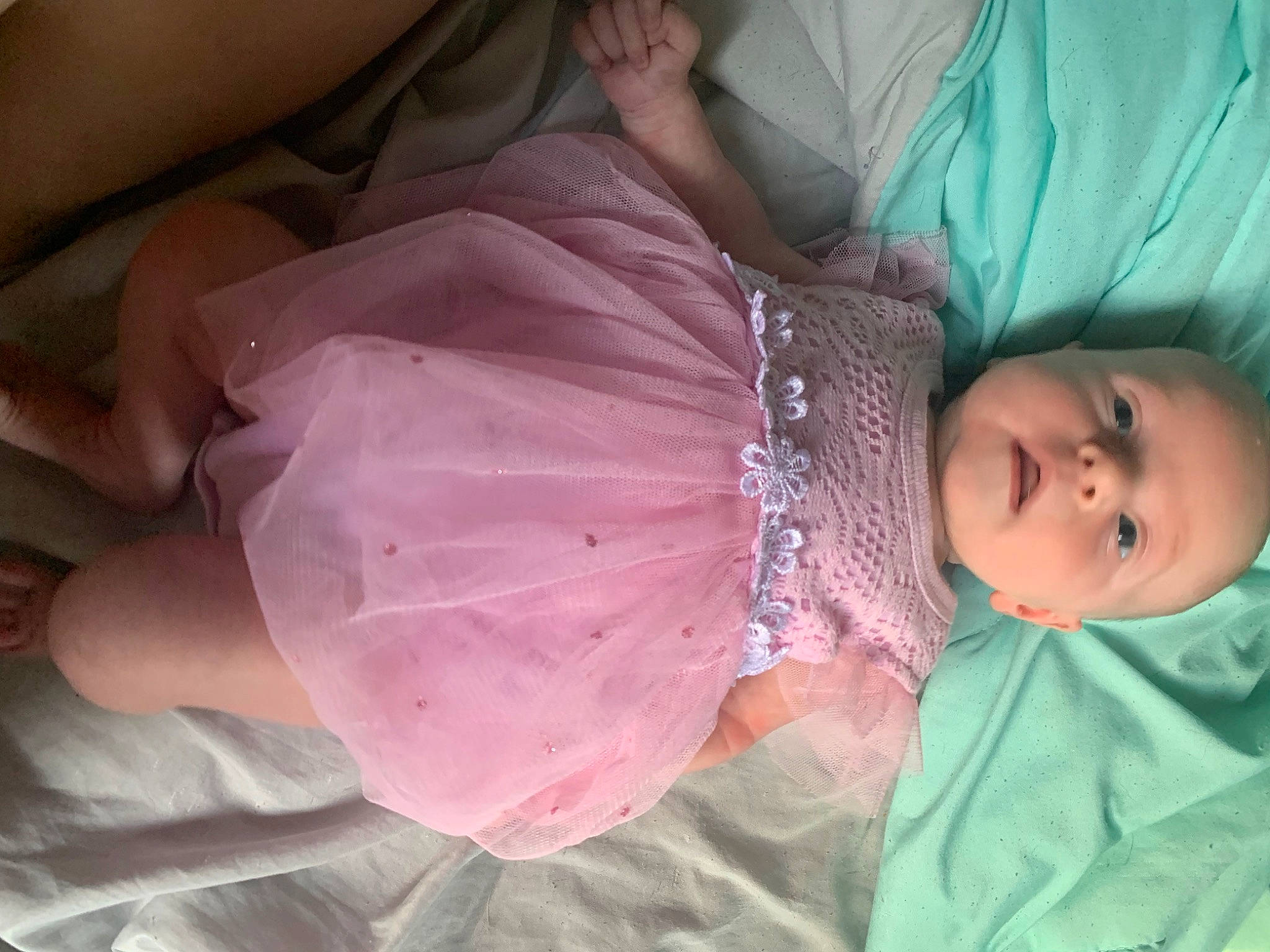 Mary is registered to the contest to win money with this photo: abdomen, baby, baby_products, baby_toddler_clothing, child, comfort, day_dress, dress, embellishment, event, fashion_accessory, hand, happy, head, magenta, peach, person, pink, room, skin