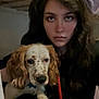 Bruno joined the competition — help win amazing prizes! person, dog, indoor, portrait, long_hair, spotted_dog, brown_ears, calm_expression, close_up, pet, animal, young_adult, casual_clothing, face, looking_at_camera, holding_pet, dark_background, mixed_light, companion, friendship