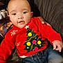baby, casual_clothing, child, christmas_tree, couch, cozy, cute, face, festive, hand, holiday, indoor, jeans, parent, person, portrait, red_sweater, seated, smiling, warm