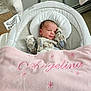 newborn, baby, infant, baby_swing, blanket, pink_blanket, floral_onesie, sleeping, cozy, indoor, baby_bedding, child, cute, resting, soft_texture, home, comfort, baby_accessory, portrait, peaceful