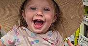 Nova joined the competition — help win amazing prizes! toddler, child, shopping_cart, hat, straw_hat, smiling, happy, indoor, store, aisle, clothing, patterned_shirt, purple_pants, person, cute, playful, retail, colorful, baby, fun