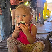 Nova joined the competition — help win amazing prizes! toddler, child, cupcake, food, eating, pink_tank_top, floral_leggings, blue_eyes, indoor, people, play_structure, cushion, casual_clothing, messy_nose, sitting, party, background, fun, young_child, light