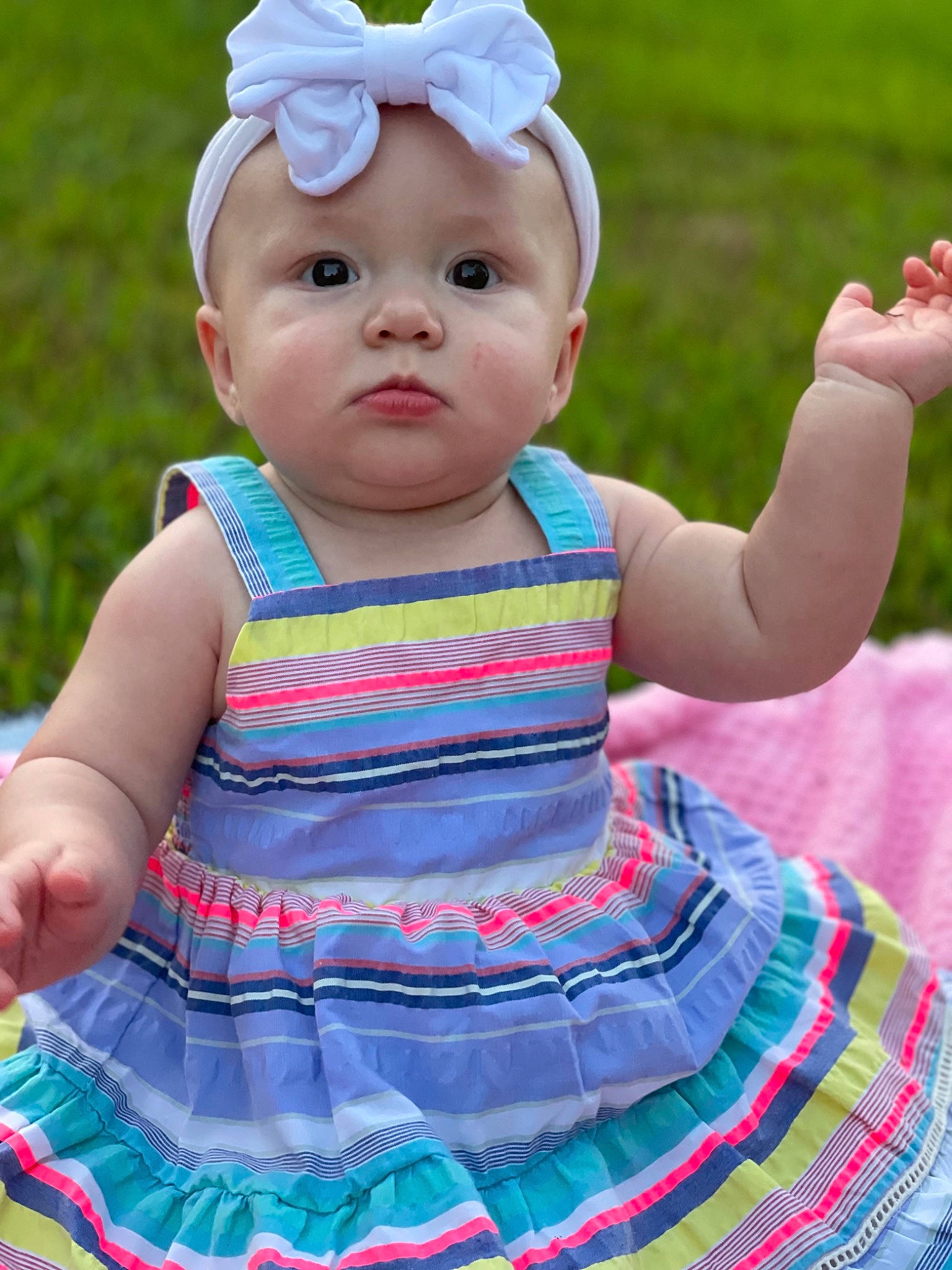 Brinleigh is registered to the contest to win money with this photo: baby, baby_toddler_clothing, cap, child, clothing, day_dress, electric_blue, face, fun, grass, green, happy, headwear, magenta, one_piece_garment, pattern, person, photograph, pink, skin