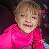 Via is registered to the contest to win money with this photo: child, smiling, blue_eyes, pink_clothing, portrait, happy, young, casual, indoor, person, cute, face, sitting, childhood, joy, playful, expression, hair, closeup, apparel
