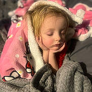 Via is registered to the contest to win money with this photo: child, sleeping, blanket, pink, gray, cozy, bed, hands, face, closed_eyes, soft_light, resting, indoor, portrait, comfort, warm, peaceful, young, cute, relaxed