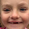 child, face, smile, blue_eyes, close_up, portrait, young, missing_teeth, pink_clothing, happy, skin, eyebrows, person, cute, childhood, expression, innocence, natural_light, human, young_face