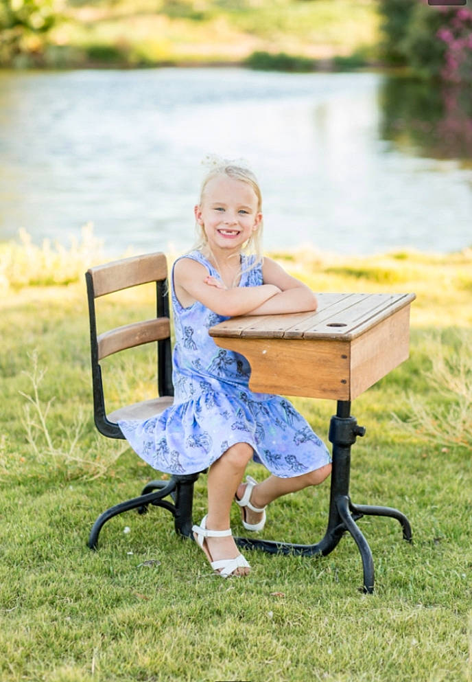 Lilly-ann joined the competition — help win amazing prizes! backyard, chair, child, folding_chair, furniture, grass, joy, lawn, leisure, outdoor_furniture, outdoor_table, person, plant, recreation, sitting, spring, summer, table, toddler, vacation