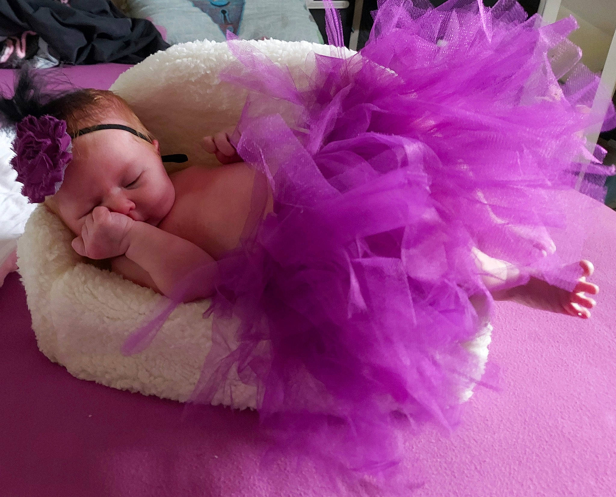 Yliana a rejoint le concours — aidez-le/la à gagner de superbes lots ! baby, baby_toddler_clothing, cap, comfort, costume, costume_hat, doll, event, fashion_accessory, fur, hair_accessory, headband, headpiece, jewellery, magenta, person, petal, pink, purple, toy