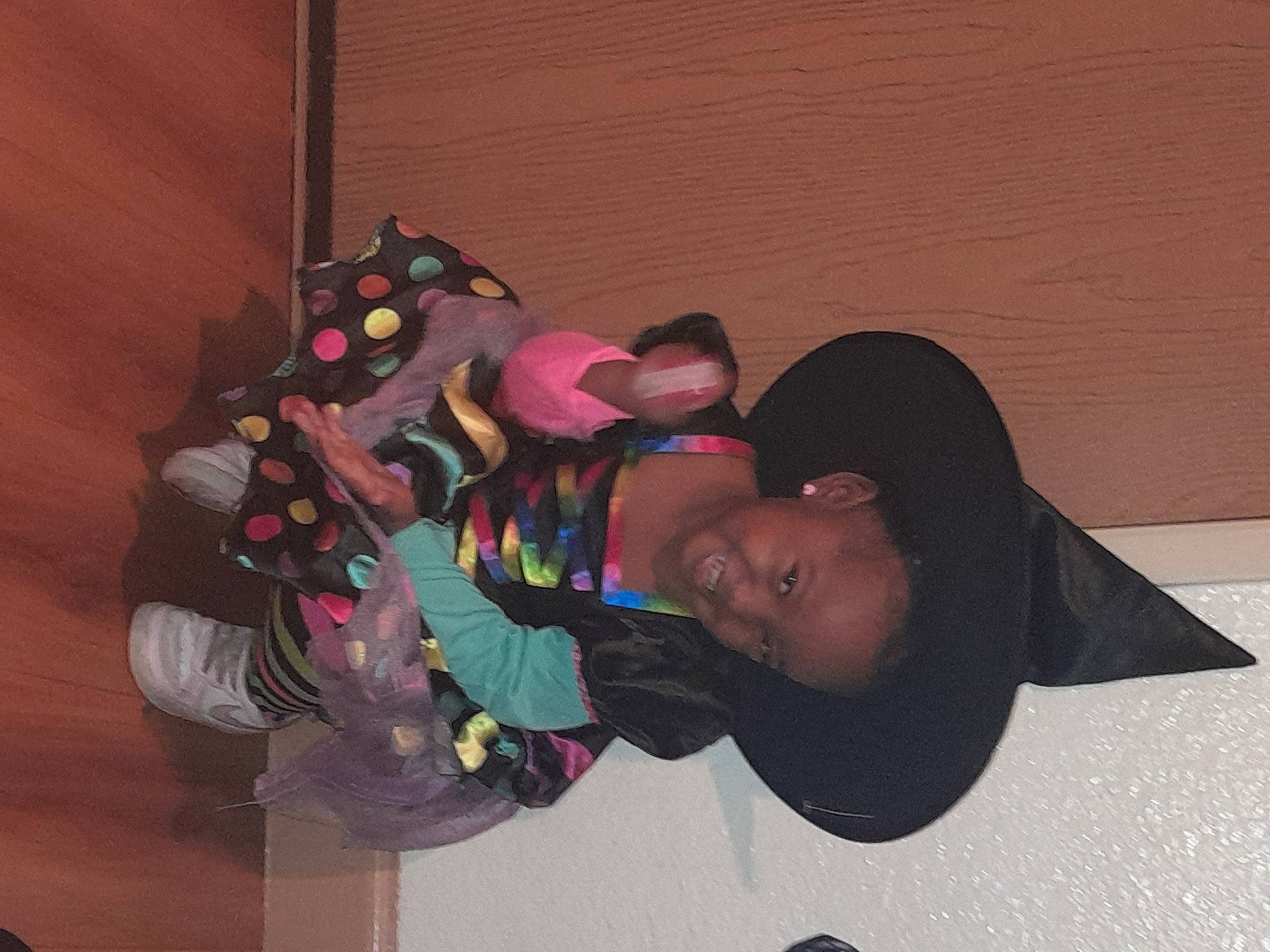 Kyra is registered to the contest to win money with this photo: animation, child, costume, event, fun, gesture, happy, hat, joy, person, personal_protective_equipment, play, room, smile, t_shirt, toddler