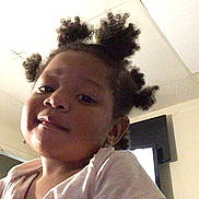 Ja'Mir is registered to the contest to win money with this photo: child, girl, indoor, portrait, hair_buns, face, smile, young, person, ceiling, room, door, television, casual_clothing, happy, cute, headshot, home, light, skin
