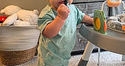 Kaiser joined the competition — help win amazing prizes! toddler, child, toy, pajamas, barefoot, carpet, basket, plush_toy, drawer, furniture, indoor, person, standing, baby, play_table, room, cute, young_child, hand, face