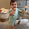 toddler, child, toy, pajamas, barefoot, carpet, basket, plush_toy, drawer, furniture, indoor, person, standing, baby, play_table, room, cute, young_child, hand, face