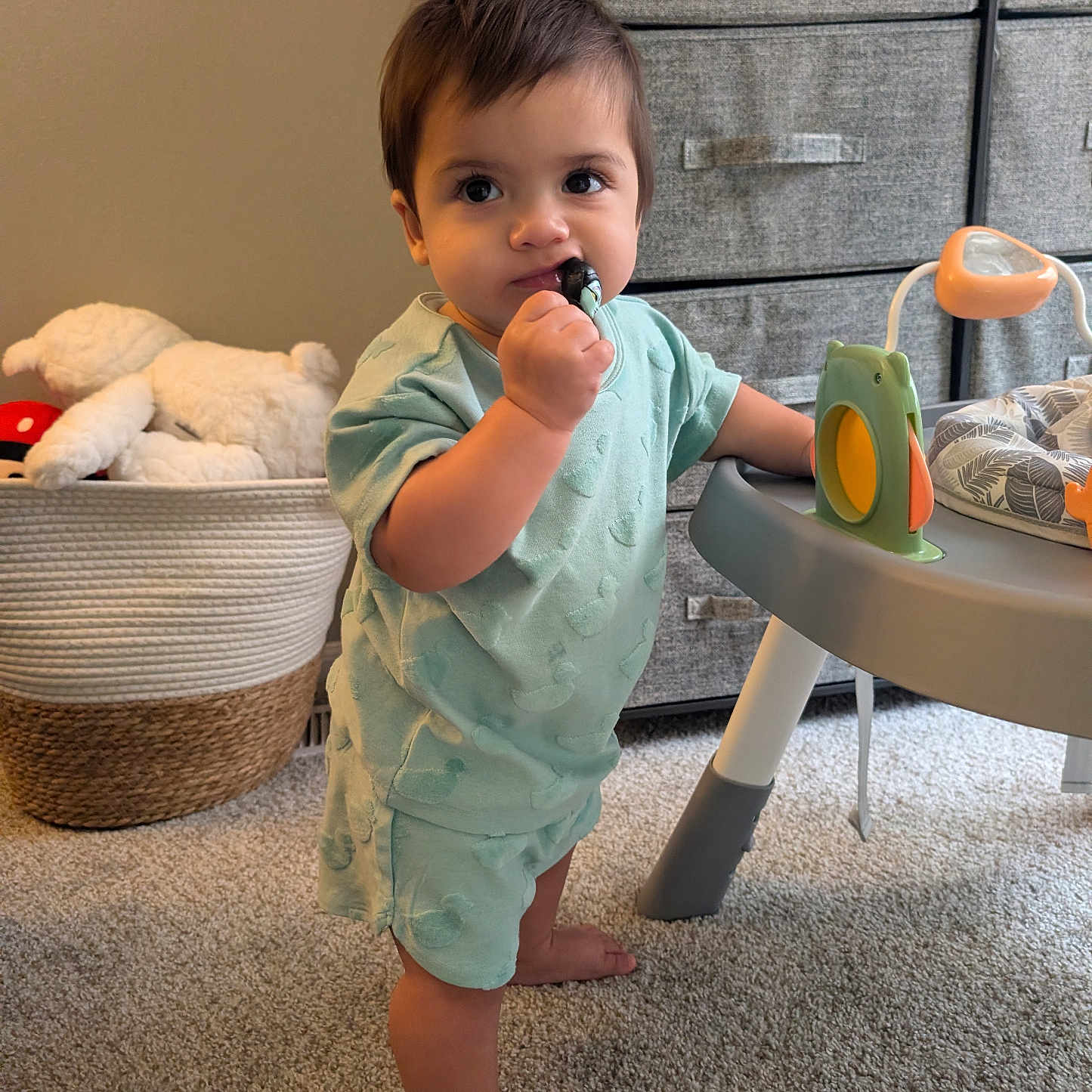 Kaiser joined the competition — help win amazing prizes! toddler, child, toy, pajamas, barefoot, carpet, basket, plush_toy, drawer, furniture, indoor, person, standing, baby, play_table, room, cute, young_child, hand, face