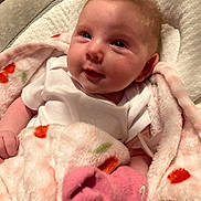 Bobbie joined the competition — help win amazing prizes! baby, blanket, pink_sock, onesie, infant, cute, smile, face, soft_texture, newborn, wrapped, comfortable, lying_down, hand, indoor, child, cozy, warm, head, skin