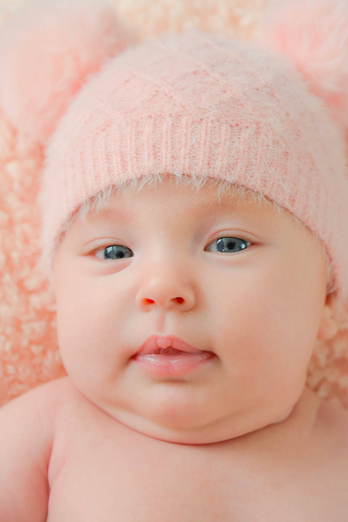 Emma is registered to the contest to win money with this photo: baby, cap, cheek, chin, eye, eyebrow, eyelash, face, happy, hat, headgear, headwear, iris, lip, mouth, nose, organ, person, pink, skin