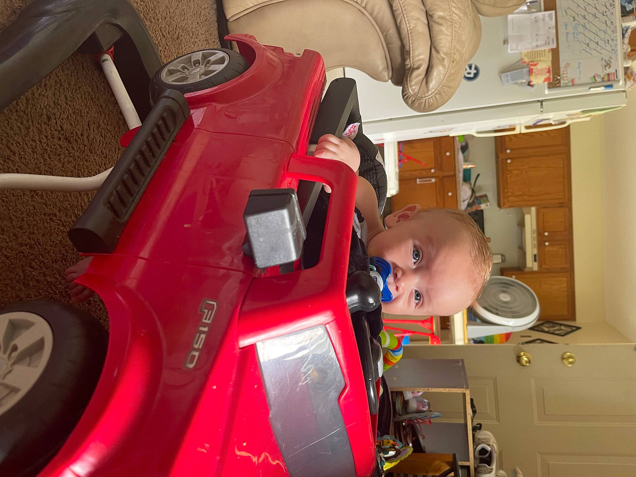 Tucoma Jr is registered to the contest to win money with this photo: automotive_design, automotive_exterior, automotive_lighting, automotive_tire, bumper, child, fender, helmet, machine, motor_vehicle, person, personal_protective_equipment, rim, service, shelf, tire, toddler, vehicle, vehicle_door, wheel