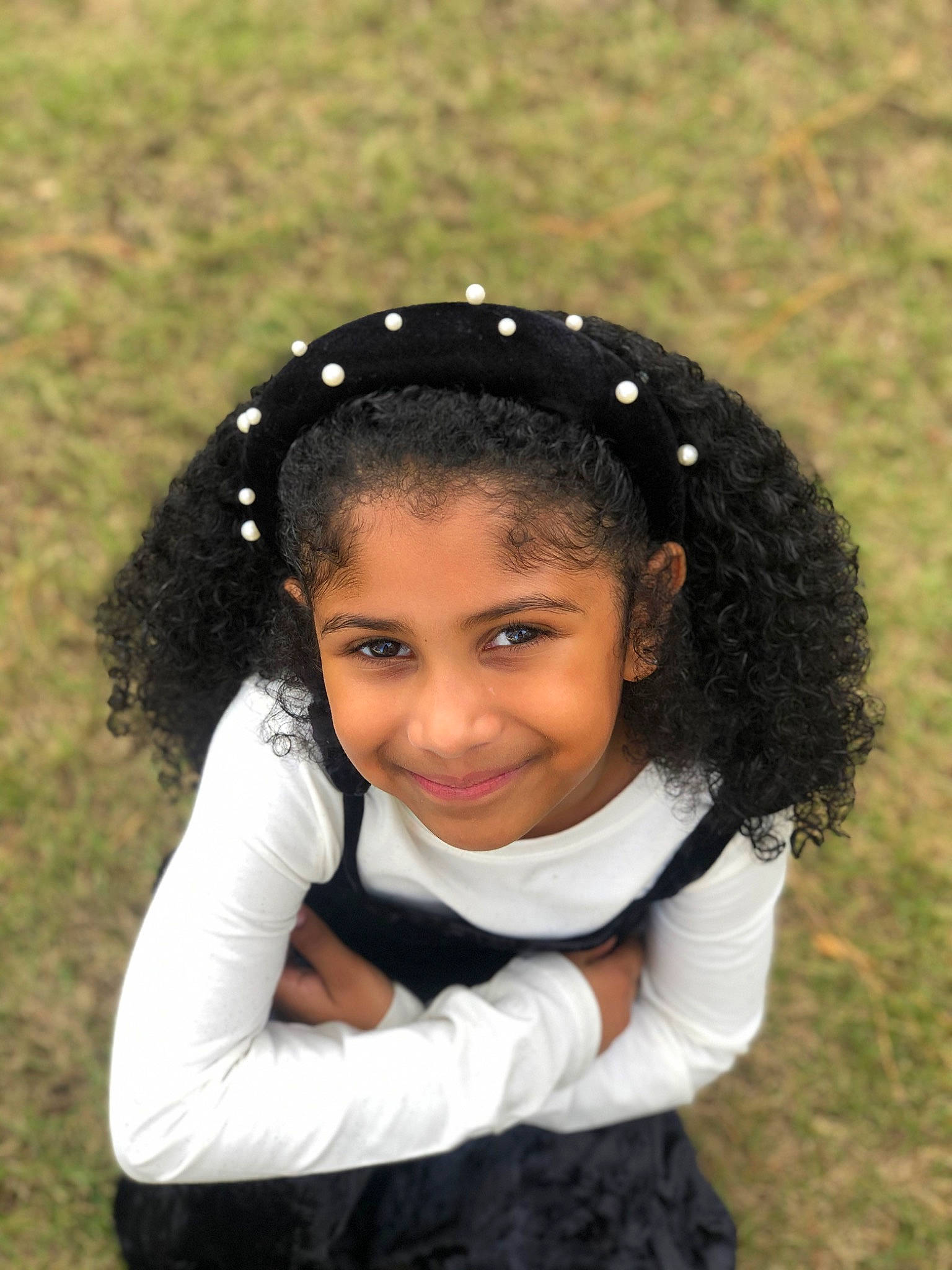 Nuriyah is registered to the contest to win money with this photo: black_hair, child, close_up, eyebrow, face, fashion_accessory, flash_photography, forehead, fun, grass, grassland, hair_accessory, happy, headpiece, joy, lip, long_hair, neck, nose, people_in_nature