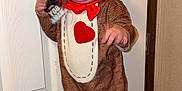 Ricky joined the competition — help win amazing prizes! toddler, child, costume, sock_monkey, indoor, floor, wooden_floor, door, keys, smile, happy, red_bow, plush_costume, face, person, cuteness, baby, playful, standing, home