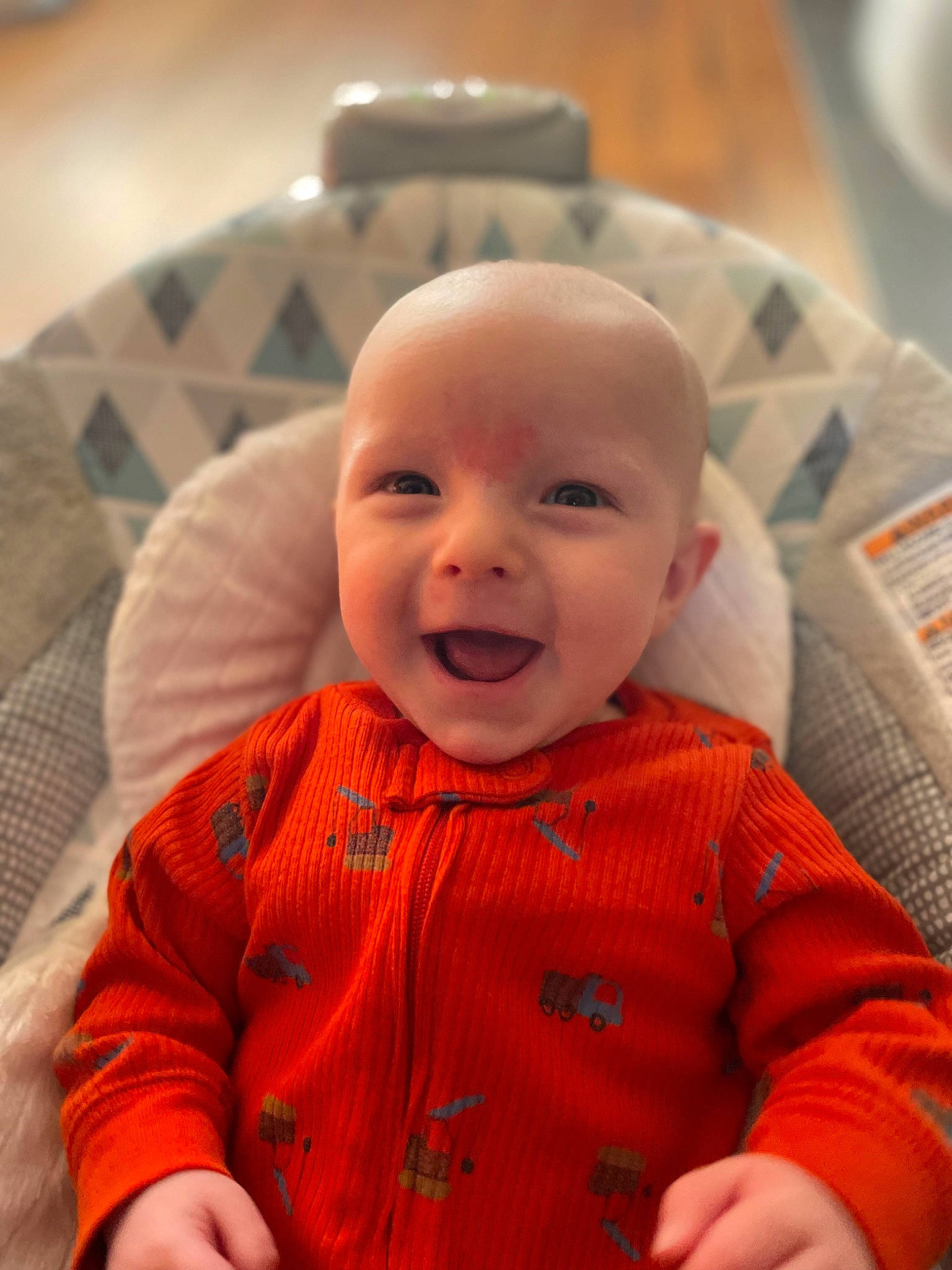 Tate is registered to the contest to win money with this photo: baby, baby_laughing, baby_toddler_clothing, cheek, chin, clothing, comfort, facial_expression, happy, head, iris, joy, lip, mouth, nose, outerwear, person, sitting, skin, sleeve
