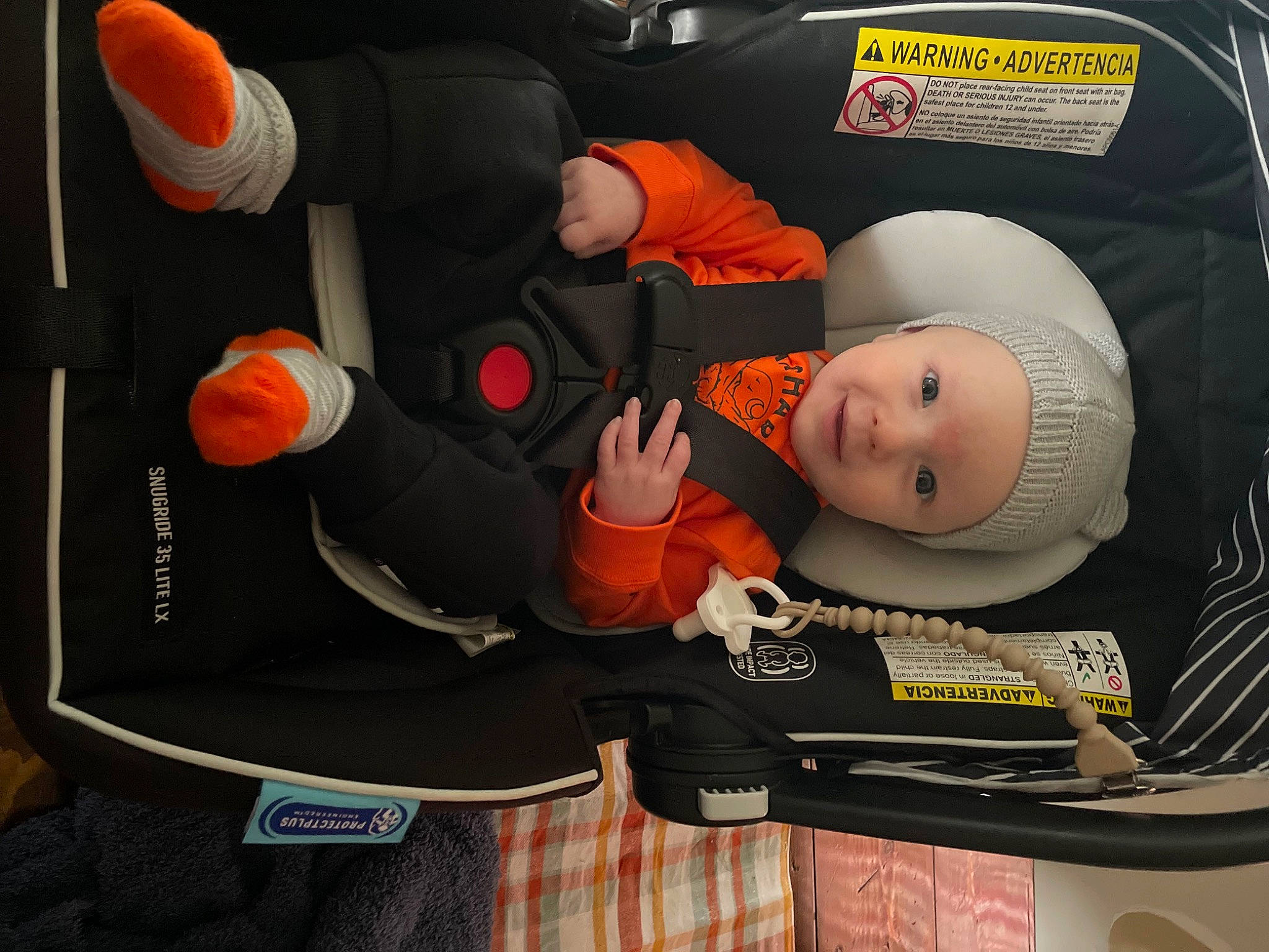 Tate joined the competition — help win amazing prizes! audio_equipment, auto_part, baby, baby_carriage, baby_products, baby_safety, baby_toddler_clothing, car_seat, carmine, child, comfort, fashion_accessory, font, headwear, orange, person, personal_protective_equipment, plastic, product, room