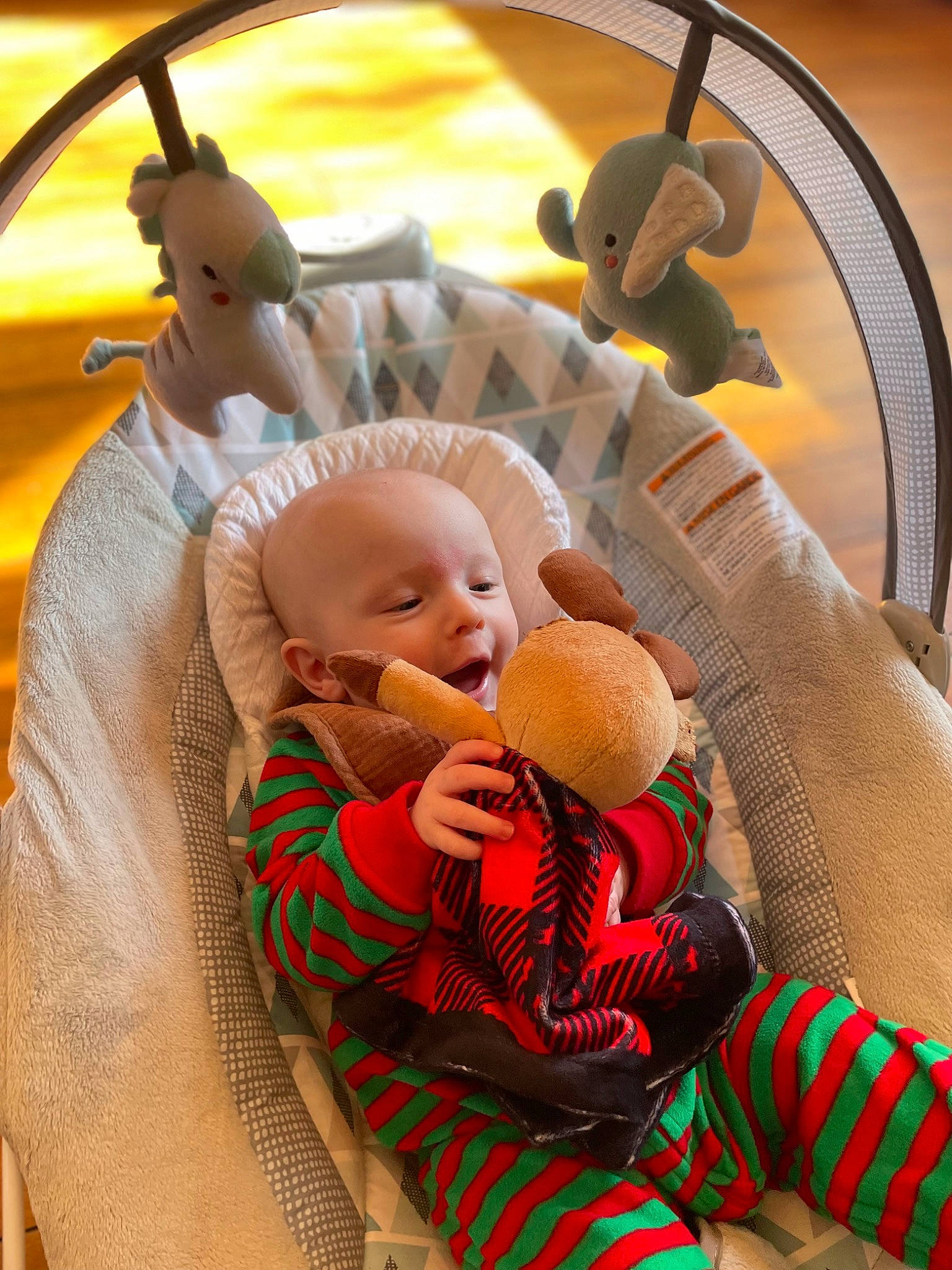 Tate is registered to the contest to win money with this photo: baby, baby_carriage, baby_products, baby_toddler_clothing, child, comfort, couch, event, fun, happy, lap, leisure, pattern, person, plaid, play, room, sitting, stuffed_toy, toddler
