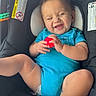 Exavian is registered to the contest to win money with this photo: baby, car_seat, blue_onesie, smiling, toy, infant, white_sock, happy, child, seatbelt, child_safety, cute, indoors, cheerful, small_child, person, car_interior, relaxed, playful, toddler