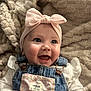 baby, smiling, headband, bow, denim_overalls, blue_eyes, happy, infant, cute, child, clothing, cozy, blanket, soft, portrait, closeup, indoor, person, apparel, baby_fashion