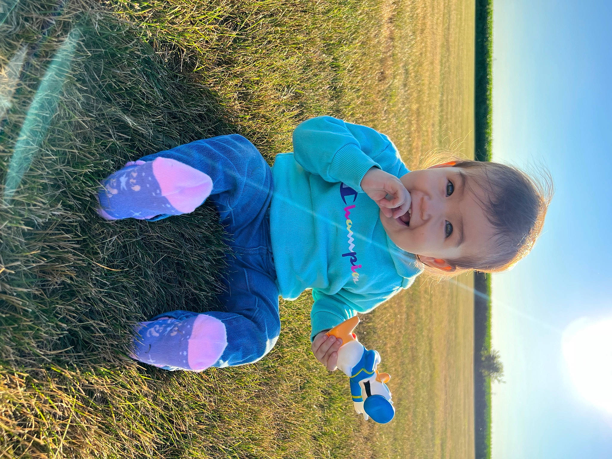 Natalia is registered to the contest to win money with this photo: azure, baby, baby_toddler_clothing, child, cloud, electric_blue, flash_photography, fun, grass, happy, leisure, people_in_nature, person, play, recreation, sky, smile, soil, toddler, water