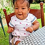 Renata a rejoint le concours — aidez-le/la à gagner de superbes lots ! baby, baby_food, child, clothing, dress, face, food, garden, greenery, happy, high_chair, outdoor, pattern, person, pigtails, pink, smiling, table, toddler, wooden_chair