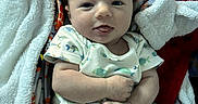 Kacee joined the competition — help win amazing prizes! baby, infant, blanket, onesie, fish_pattern, cute, smiling, face, skin, hand, legs, cozy, soft, child, young, lying_down, indoors, comfortable, happy, expressive