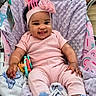 Nevaeh-Celeste is registered to the contest to win money with this photo: baby, infant, smiling, pink_clothing, headband, bow, blanket, toy, baby_seat, cozy, happy, cute, child, cheerful, indoors, soft_texture, person, footwear, hand, face
